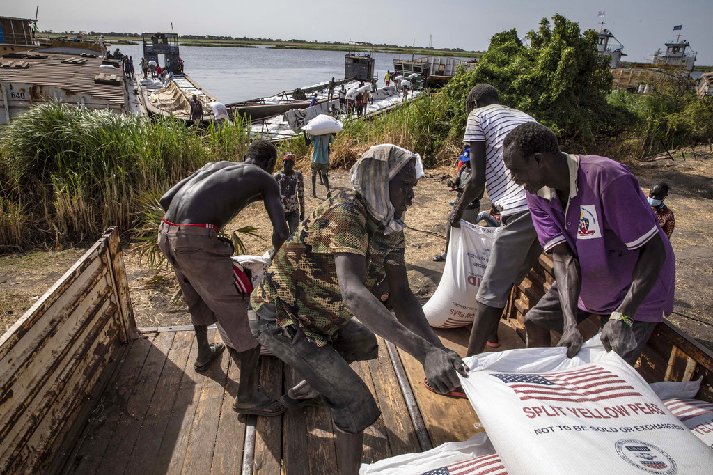 Sacks of split peas are transported to Jonglei State via the White Nile River in South Sudan.